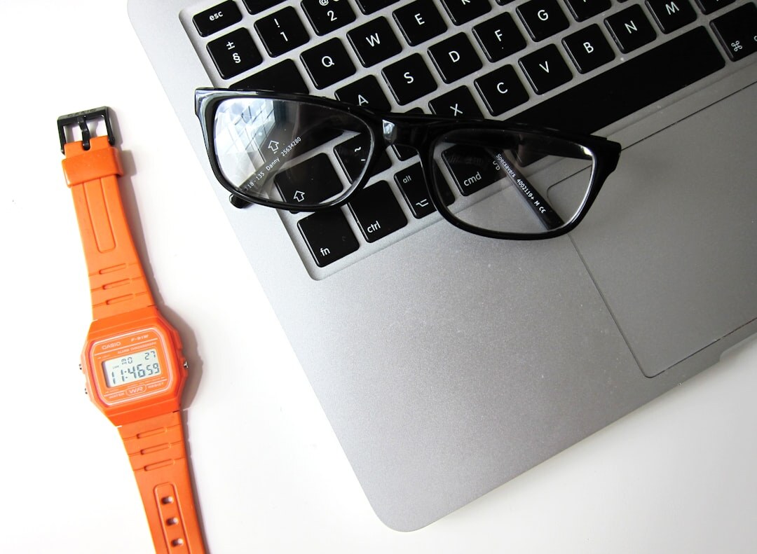 Bright office desk with laptop, notebook and calculator