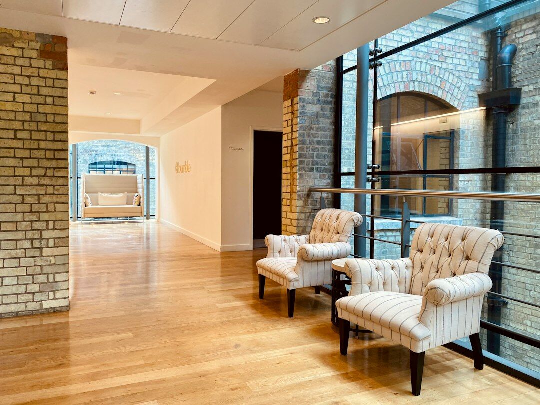 Bright modern office reception area with plants and seating
